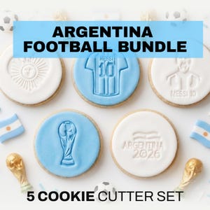 May include: An Argentina football bundle with five cookie cutters. The cutters feature designs of a jersey, the sun, a trophy, and the text "Argentina 2026". The text "Argentina Football Bundle" is in a blue rectangle.