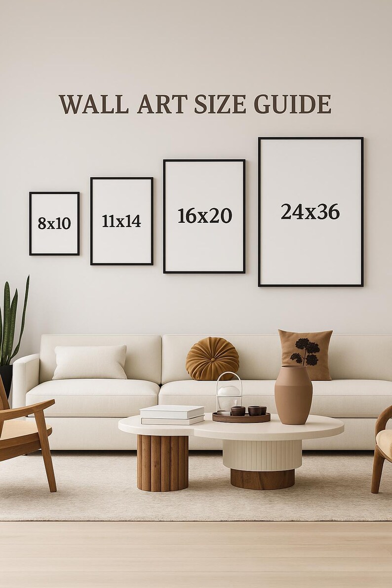 May include: A wall art size guide displays four framed prints: 8x10 inches, 11x14 inches, 16x20 inches, and 24x36 inches. The text "WALL ART SIZE GUIDE" is above the prints. The scene includes a white sofa, coffee table, and decorative items.