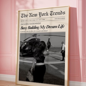 May include: A framed print featuring a black and white photograph of a helicopter and a person. The print has text that reads "The New York Trends" and "Busy Building My Dream Life."