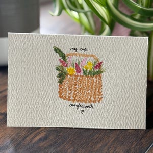 Cartão de felicitações com cesta de flores em aquarela feita à mão