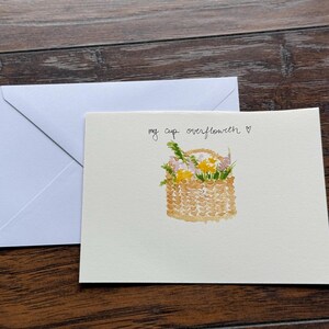 Cartão de felicitações com cesta de flores em aquarela feita à mão