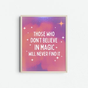 May include: Framed art print with a dreamy, colorful background of pink, purple, and blue hues. The white text reads: "THOSE WHO DON'T BELIEVE IN MAGIC WILL NEVER FIND IT." Small white star accents are scattered around the text.