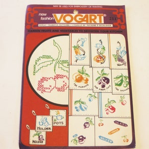 May include: A vintage package of iron-on transfer patterns for embroidery or crafting. The package features a colorful design of fruits and vegetables with the text "GARDEN FRUITS AND VEGETABLES TO BRIGHTEN YOUR KITCHEN" and "new fashion VOGART 211".