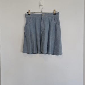 Vintage 1990s Y2K high-waist denim skater flippy mini skirt. Vintage Clothing by VintageTwists.