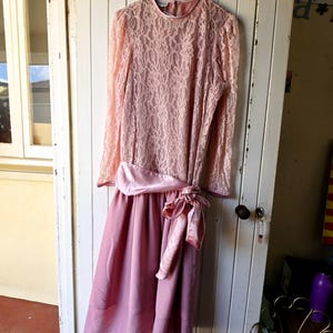 Vintage 1980s pink drop-waist lace and swishy soft skirted dress with feature sash belt and bow situation. Vintage Clothing by VintageTwists