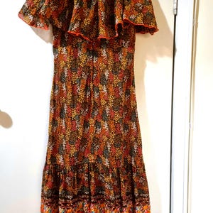 Vintage 1970s floral midi dress with ruffle hem. Vintage Clothing by Vintage Twists.