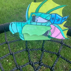 Green Sea Dragon Puppet. Coloured with alcohol markers, watercolours, and acrylic paint pens. Double layered cardstock paper.