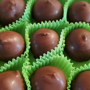 May include: A set of three ceramic mugs with a speckled, matte finish. The mugs are in shades of cream, light brown, and dark brown. Each mug has a simple, minimalist design, perfect for coffee or tea.