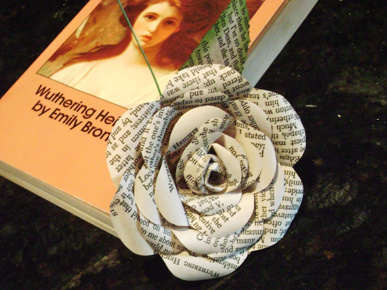 May include: A white paper flower made from pages of the book "Wuthering Heights" by Emily Bronte.