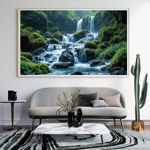May include: A framed print depicting a waterfall flowing over mossy rocks. The water gathers in a pool, surrounded by green plants. The artwork hangs above a grey sofa, with a marble coffee table and a patterned rug in the room.