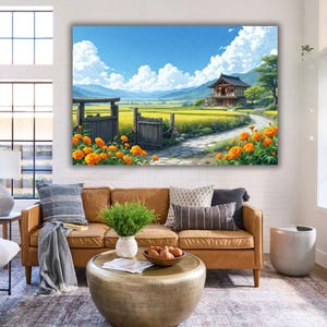 May include: A large canvas print depicts a serene Japanese landscape. A traditional house sits near a path, surrounded by golden fields and orange flowers. The sky is blue with fluffy white clouds. The print is displayed above a brown leather sofa.