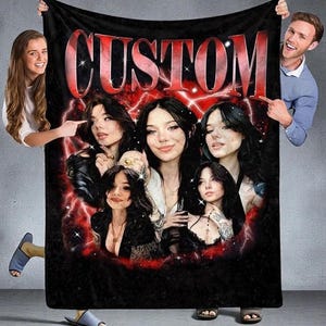 May include: Black blanket with a custom design featuring multiple portraits of a person, surrounded by a red lightning bolt design. The word "CUSTOM" is printed in large, red, outlined letters at the top.