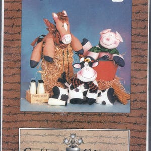 May include: A colorful image featuring handmade beanbag farm animals: a horse, pig, and cow. The horse and pig are perched on hay, while the cow is seated. The image includes a carton of milk and the text "Barnyard Pals".