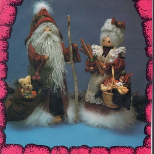 May include: A vintage Christmas craft pattern featuring two Hob Knobs dolls. One doll is a Santa figure with a long white beard and a sack with a teddy bear. The other doll is a woman with a basket. The pattern includes text.