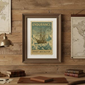 May include: A framed print of a vintage postage stamp depicting a sailing ship amidst icebergs. The stamp is labelled "Endurance" and "Ernest Shackleton". The artwork uses blue, brown, and cream tones, set within a brown wooden frame.