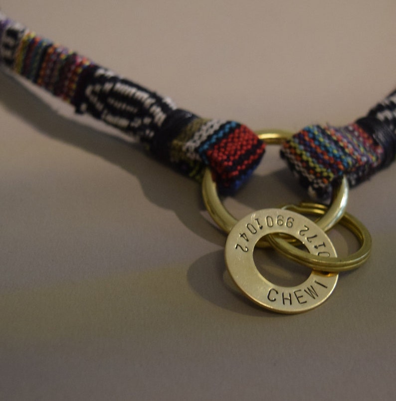 May include: A colorful woven dog collar with a brass tag that reads "CHEWI 2172 066 1072".
