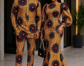 May include: A long-sleeved shirt and matching trousers set alongside a floor-length dress with long puff sleeves, both featuring a vibrant yellow, maroon, and dark blue circular geometric pattern on a textured background with a black handbag.