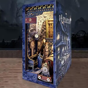 May include: A detailed, illuminated diorama of a train station scene. The model features a train, clock tower, and a sign that reads "Hogwarts Express". The exterior is a dark blue with the words "9 3/4 Station".