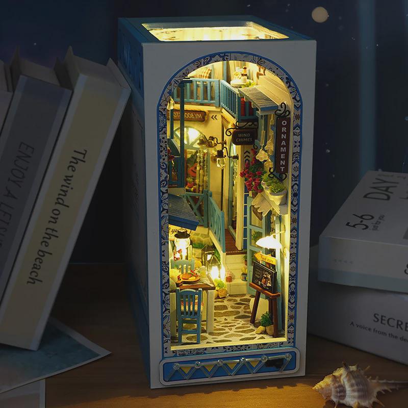 Greek Street Book Nook DIY Kit – Miniature Cobblestone Road with Blue Balconies, Dinner Table & Warm Lights | 3D Bookshelf Diorama