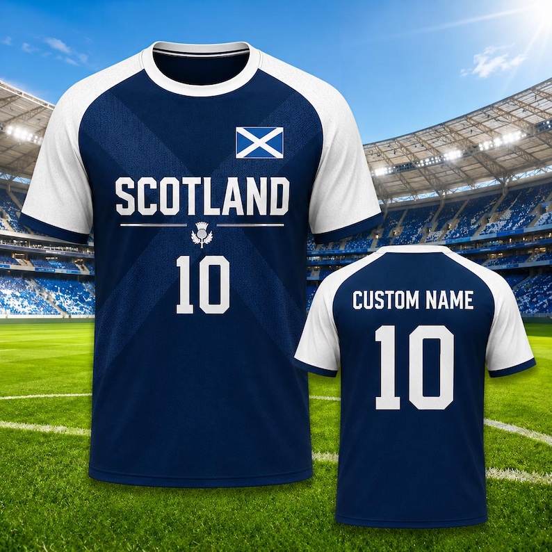 May include: A navy blue and white soccer jersey with the word "SCOTLAND" and the number "10" printed on the front. The Scottish flag is displayed on the upper chest. The back of the jersey has "CUSTOM NAME" and the number "10".