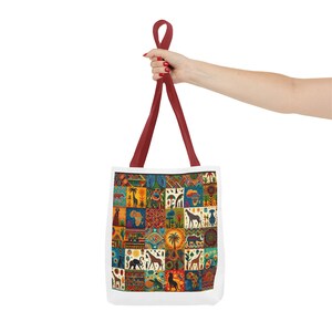 May include: White tote bag with a colorful African-themed patchwork design. The bag features a variety of animal and plant illustrations, including giraffes, elephants, and palm trees. The handles are a deep red color.