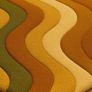May include: A retro-style rug with a wavy pattern in shades of green, gold, and brown. The rug has a textured, plush surface, and the design creates a sense of movement and visual interest. The rug's colors evoke a warm, earthy aesthetic.