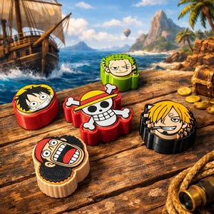 May include: Six colorful, character-shaped items from the One Piece anime series are arranged on a wooden surface. The characters include Luffy, Zoro, Sanji, and others, each with distinct facial features and colors. The background features a pirate ship, ocean, and tropical island.