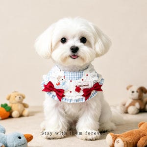 May include: A small white dog wearing a blue and white gingham bib with red bows and a frill trim. The bib has a cartoon design and the word "Furrever". The text "Stay with them forever" is at the bottom.