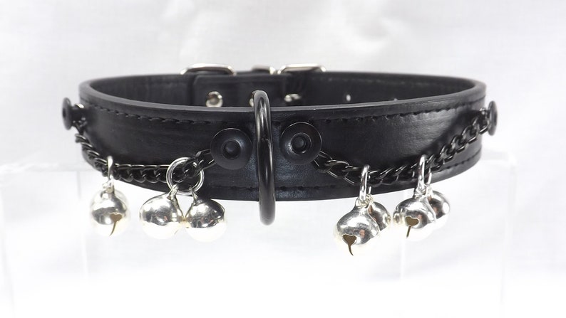 Jingle bells collar with black front dee ring. Black chains and silver bells black leather collar. Bdsm slave bell collar.