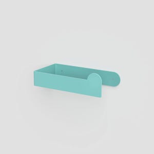 May include: A light turquoise metal wall-mounted shelf with a U-shaped design. The shelf features a flat base, two vertical sides, and a rounded decorative tab on the right side. Two small circular mounting holes are visible on the back panel.