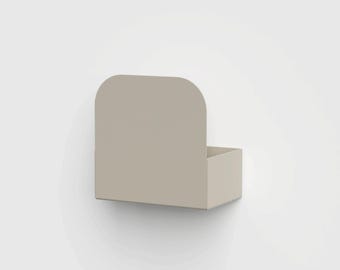 May include: A beige wall-mounted storage bin featuring a rectangular base and a tall, rounded back panel. The unit is constructed from a solid, smooth material with clean edges and a uniform matte finish, designed for organizing small items.