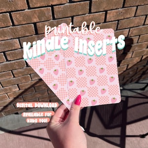 May include: Printable Kindle inserts with a pink strawberry pattern and the text "Kindle Inserts". The inserts are held by a person with pink nail polish. The words "Digital Download" and "Available for Kobo too!" are also visible.