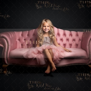 May include: A young girl wearing a gray and pink dress sits on a pink tufted sofa. The sofa has a dark background.