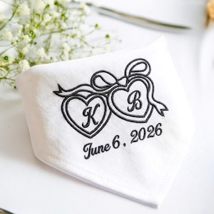 May include: White handkerchief with black embroidered design. Features two connected hearts with the letters "K" and "B", and a ribbon. The date "June 6, 2026" is also embroidered on the handkerchief.