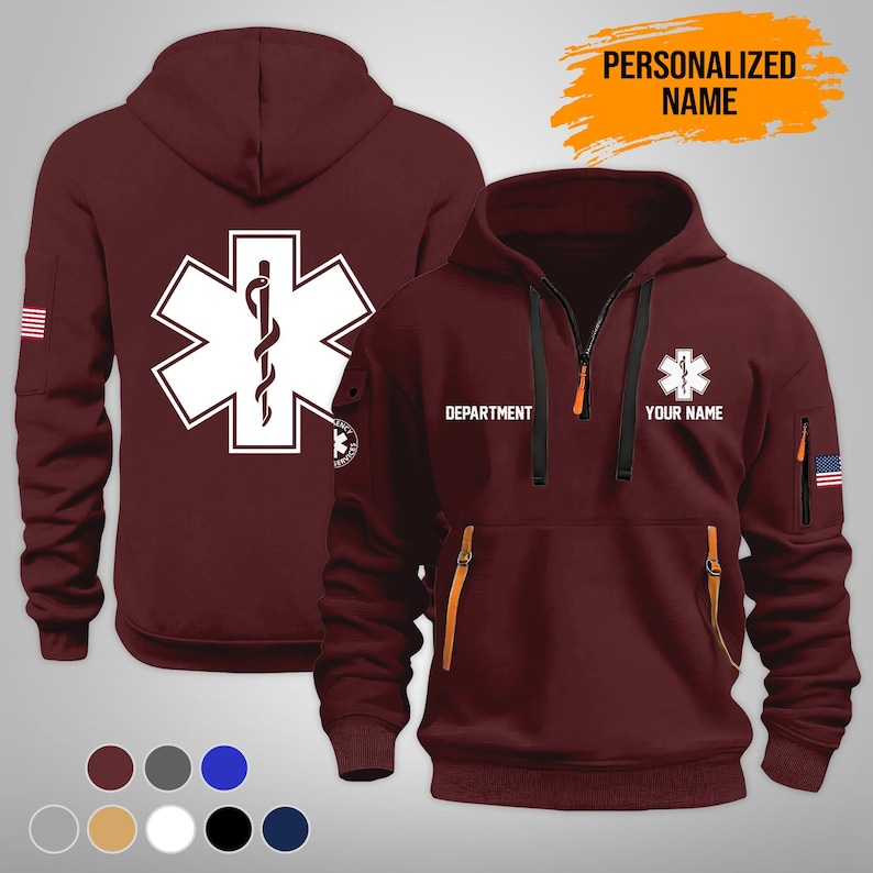 Puede incluir: Sudadera con capucha burdeos con un emblema blanco de la Estrella de la Vida en la espalda y en la parte delantera. La parte delantera presenta el texto "DEPARTMENT" y "YOUR NAME". La sudadera tiene cremallera y detalles en naranja.