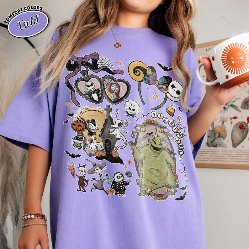 Puede incluir: Una camiseta violeta con un estampado gr&aacute;fico de personajes de Pesadilla antes de Navidad, incluyendo a Jack Skellington, Sally, Zero y Oogie Boogie, junto con iconos tem&aacute;ticos como una l&aacute;pida, telara&ntilde;as y orejas de rat&oacute;n.