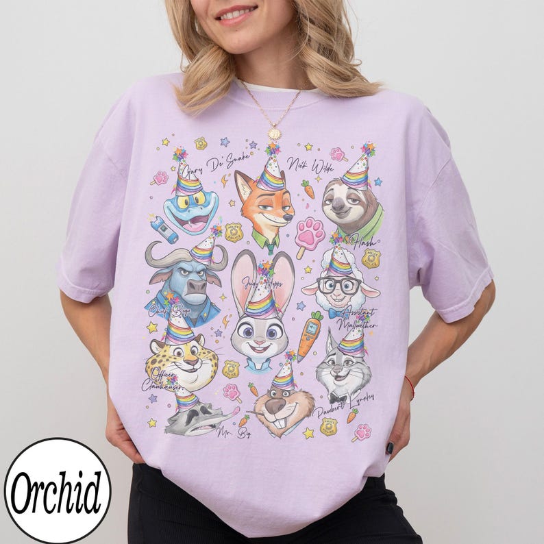 May include: A light purple t-shirt featuring cartoon characters from Zootopia, each wearing a party hat. The shirt has the word "Orchid" in a white circle at the bottom left. The characters include Judy Hopps, Nick Wilde, and Flash.