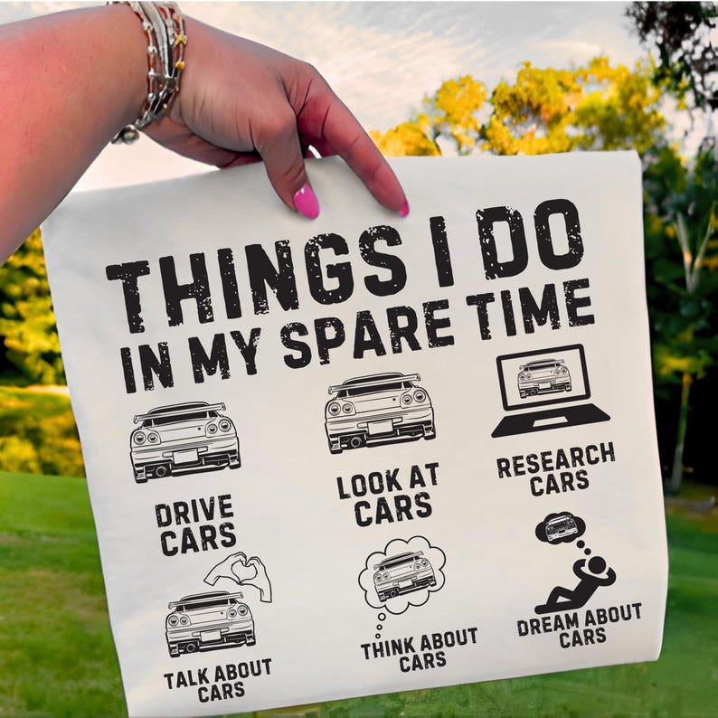 May include: Cream-coloured pillowcase featuring the text "THINGS I DO IN MY SPARE TIME" and car-related illustrations. The pillowcase also includes the phrases "DRIVE CARS", "LOOK AT CARS", "RESEARCH CARS", "TALK ABOUT CARS", "THINK ABOUT CARS", and "DREAM ABOUT CARS".