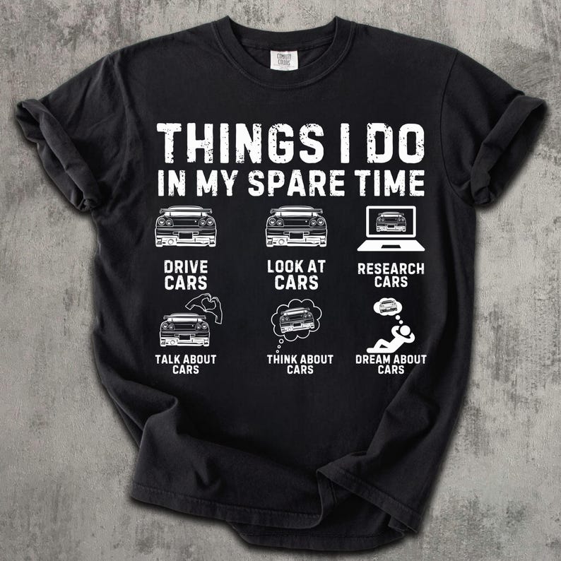 May include: Black t-shirt featuring the text "THINGS I DO IN MY SPARE TIME" in white, accompanied by car-themed graphics. The design includes images of cars, a laptop, and thought bubbles. A great gift for car lovers.