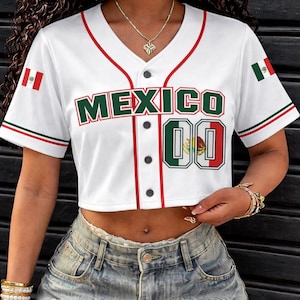 May include: White cropped baseball jersey with red and green trim, featuring the word "MEXICO" in green block letters. The jersey includes the Mexican flag on the sleeves and the number "00".