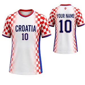 May include: White Croatia soccer jersey with red and white checkered sleeves and shoulders. The front displays "CROATIA" and the number "10" in blue. The back features "YOUR NAME" and the number "10".