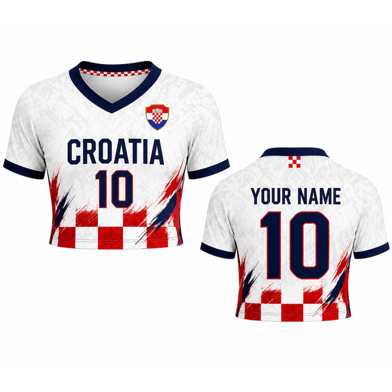 May include: White Croatia football shirt with red and blue details. The shirt displays the word "CROATIA" and the number "10" in navy blue. The front has a Croatian coat of arms. The back has the text "YOUR NAME" and the number "10".