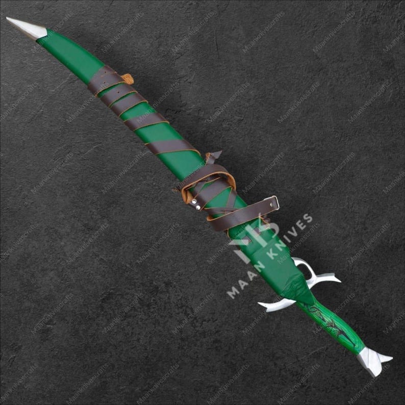 May include: A green and brown dagger with a silver blade and accents. The handle is wrapped in brown leather straps. The sheath is green with the text "MAAN KNIVES".