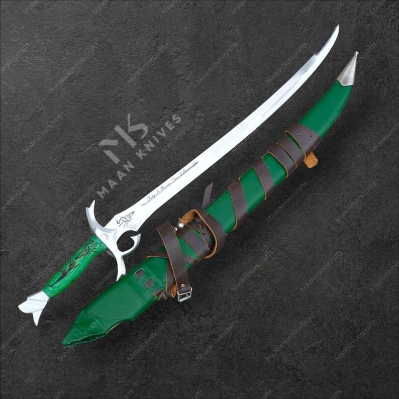 May include: A silver and green fantasy sword with a curved blade, resting on a green sheath with brown leather straps. The handle is green with silver accents. The blade is silver with etched designs. The sheath is green with brown leather straps.