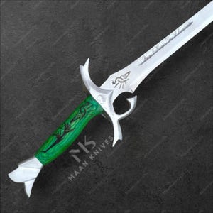 May include: A decorative sword with a silver blade and a green handle. The blade has an engraved design and the text "Duty Is Heavier Than A Mountain". The handle is green with a black design and the text "MAAN KNIVES".