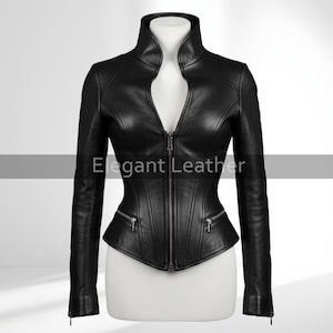 May include: A black leather jacket with a high collar and a zipper closure. The jacket has a fitted silhouette with two zippered pockets and the text "Elegant Leather". The sleeves have zippers at the cuffs.