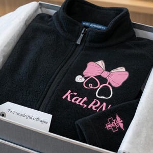 Custom Embroidered Nurse Bow Full Zip Up Fleece Jacket - Personalized RN Embroidery Zipper Jacket with Name - Womens Stethoscope Bow