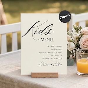 May include: A cream-colored rectangular menu sign with black text reading Kids MENU, listing chicken tenders, french fries, mini cheeseburger sliders, mac & cheese, and vanilla ice cream cup, with the names Olivia and Ethan at the bottom.