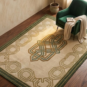 May include: A rectangular area rug featuring a cream-colored base with a raised, textured geometric pattern in shades of olive green and muted gold. The design includes a central interlocking motif surrounded by a repeating octagonal border.