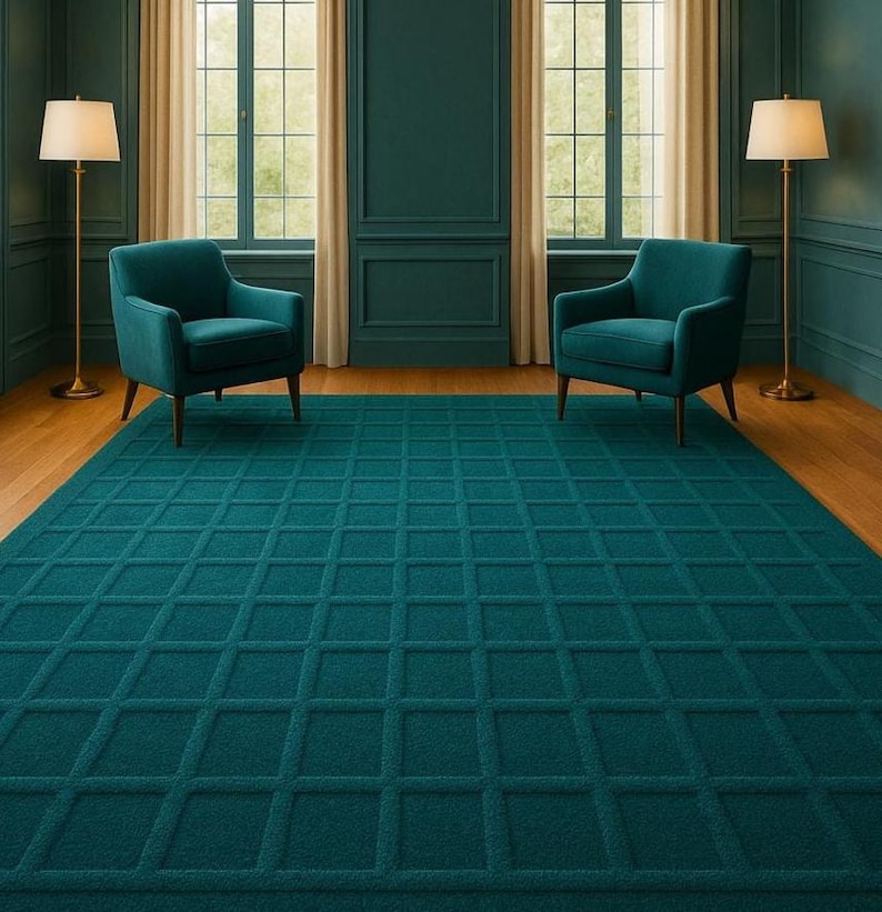Plush teal wool rug with square grid pattern, hand-tufted for premium comfort and style, perfectly complementing a contemporary living space with rich teal furniture and elegant gold lighting.